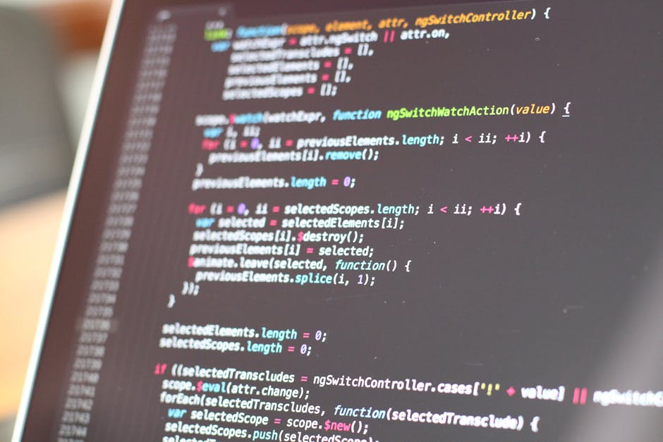 A close-up of a computer screen displaying lines of colorful coding text, including functions, variables, and syntax in various colors such as pink, blue, green, and white, on a dark background. The s